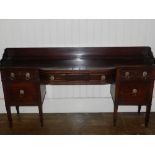 A George III mahogany sideboard, having central drawer flanked by small drawer above cupboard