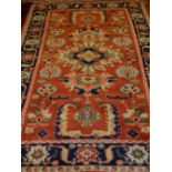 A red ground Mahal carpet, decorated with stylised flower heads to centre, within floral borders,