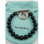 Tiffany & Co. New York. A silver and black onyx beaded bracelet.