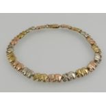 An unusual 9 carat white, yellow, and rose gold segmented elephant bracelet.