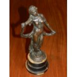 A cast bronze figure of a classical maiden, raised on circular wooden base.