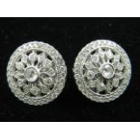 A pair of 18 carat white gold and diamond cluster ear studs, the openwork mounts set with approx.
