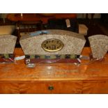 An Art Deco marble clock and garniture, the dial with Roman numerals, having eight day movement,