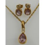 A gold-coloured metal, amethyst, and cubic zirconia set pendant, together with a pair of matching
