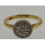 An 18 carat yellow gold and diamond circular cluster ring.