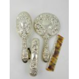 A three piece silver plated ladies dressing table set, to include a mirror, and two brushes.