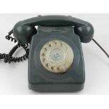 A 1970s green plastic dial telephone.