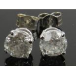 A pair of 14 carat white gold and solitaire diamond ear studs, the stones of approx. 1.80 carats