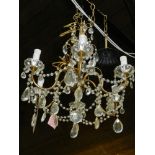 A mid 20th century gilt metal chandelier, having cut glass droplets.