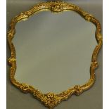 A modern Baroque-style wall mirror, with moulded foliate gilt frame. H.