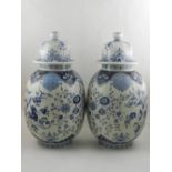 A pair of large blue and white ovoid temple jars and covers, in the Delft taste,