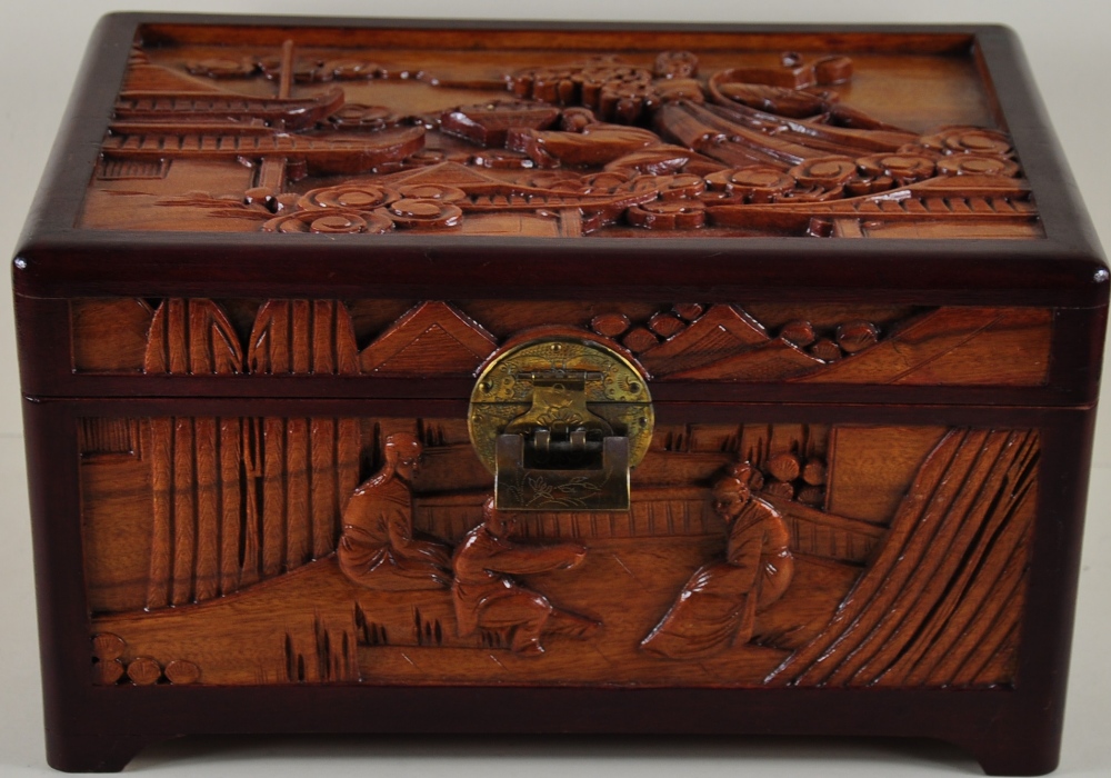 An Oriental hardwood casket with brass lock