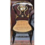 A Victorian ebonised chair with gilt and mother of pearl inlaid back over caned seat, H. 79.