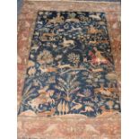 A Qum handmade wool carpet,decorated with a Shekari hunting scene on a dark blue ground,