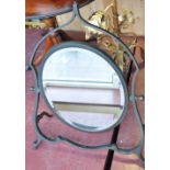 A bronze pivoting dressing table mirror with oval bevelled glass, H.