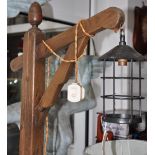 A standing floor lamp modelled as wooden beam with lantern