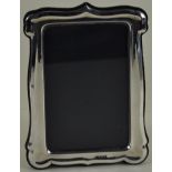 A silver mounted easel back photograph frame with glass front, hallmarked Birmingham 1990,