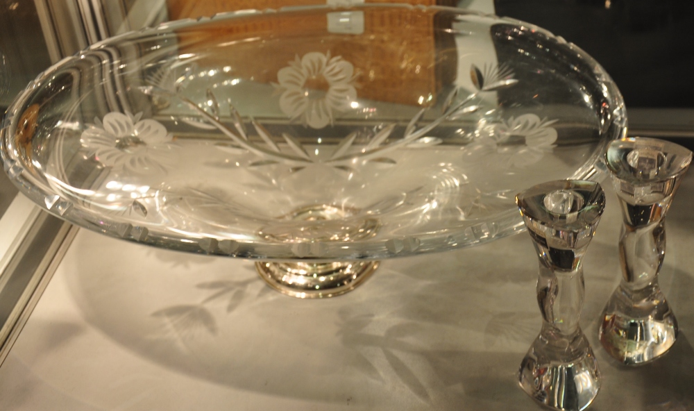 A pair of John Rocha Waterford candlesticks, a large glass platter on hallmarked silver stand,