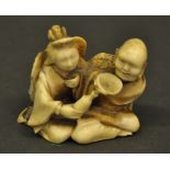 A Japanese 19th century ivory netsuke of a finely carved elderly couple,