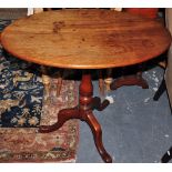 An Edwardian oak oval tilt-top occasional table on tripod base, W.