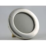 An circular silver Concorde easel photo frame,