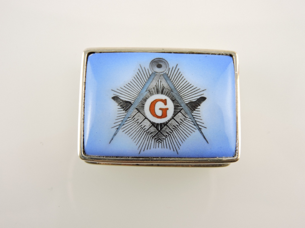 A rectangular silver box bearing blue masonic symbol to lid
