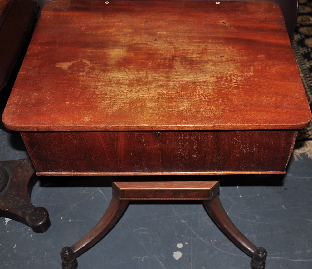 A mahogany sewing box with rising lid on four splayed feet,