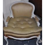 A small cream painted French style fauteuil chair upholstered in gold