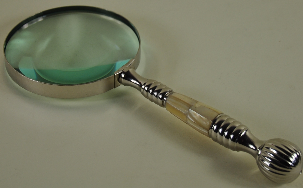 A large chrome table magnifier with a mother of pearl handle