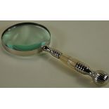 A large chrome table magnifier with a mother of pearl handle