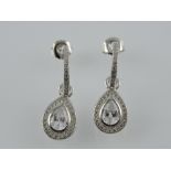 A pair of silver and cubic zirconia pear shaped drop earrings