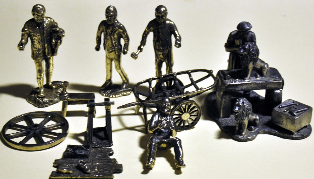 Five silvered metal figures representing a shepherd, a costermonger, a wheelwright,