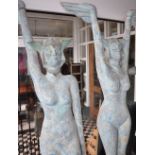 Two large life-sized figures of nude Egyptian women in various poses, blue painted,