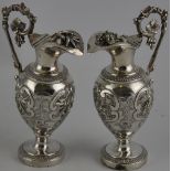 A pair of French 1st standard silver ewers