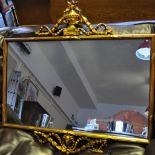 A rectangular gilt mirror with ribbon carved decoration to top and bottom,