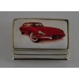 A silver oblong box with a picture of an E-type jaguar on the lid