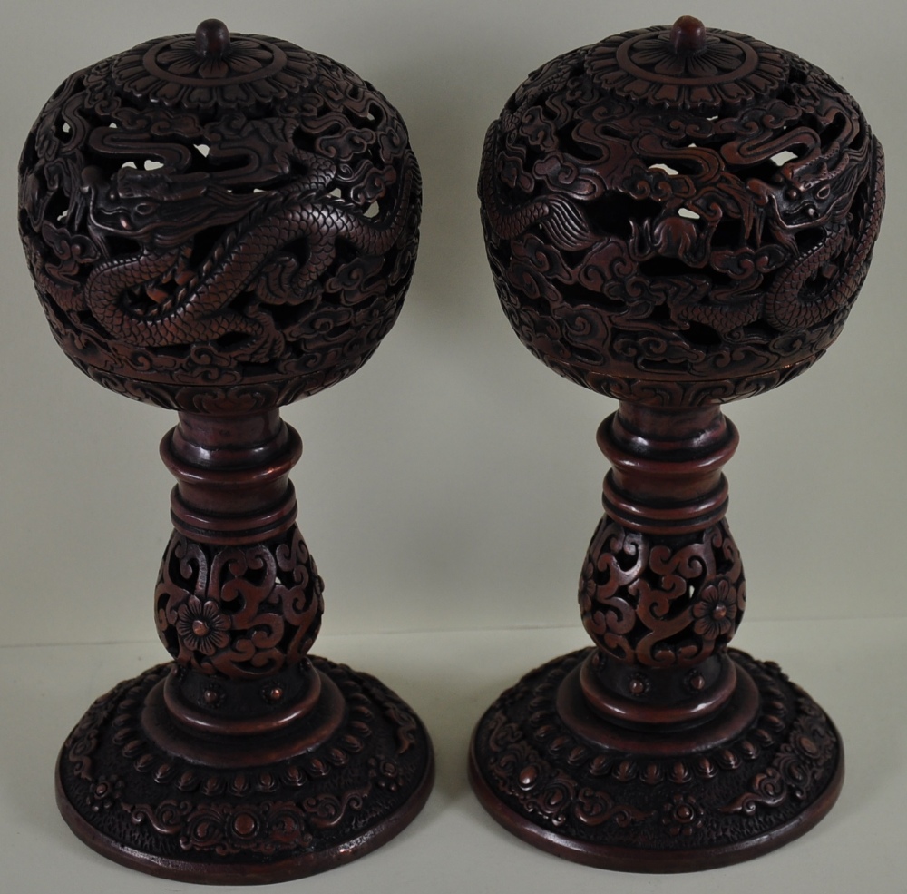 A pair of Chinese metal incense burners in the form of mandarin hat stands,