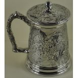 A Chinese design pint tankard with decoration forming a dragon & the lid having a flaming pearl