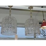 A pair of venetian style ceiling light shades of cage form.