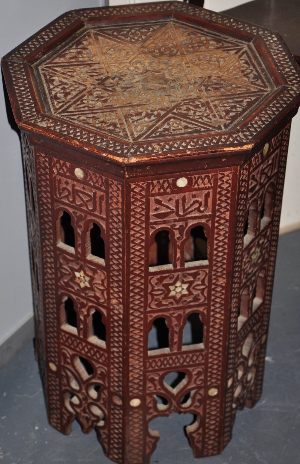 A carved wood Indian octagonal side table with inlaid mother of pearl discs, H.