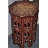 A carved wood Indian octagonal side table with inlaid mother of pearl discs, H.