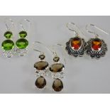Three assorted pairs of silver earrings with peridot,