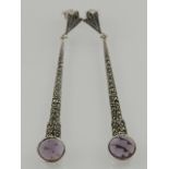 A pair of silver, marcasite, and faceted amethyst drop earrings.