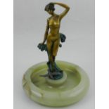 A cold painted bronze figure of a female upon stylised waves,