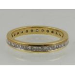 An 18 carat yellow gold and diamond set eternity ring, the stones of approx. 1 carat combined.