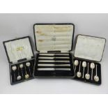 Two boxed sets of teaspoons and a boxed set of butter knives, (3).