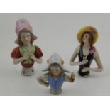 Three early 20th century ceramic pin cushion dolls (lacking cushions).