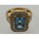 An 18 carat yellow gold, diamond and aquamarine dress ring,