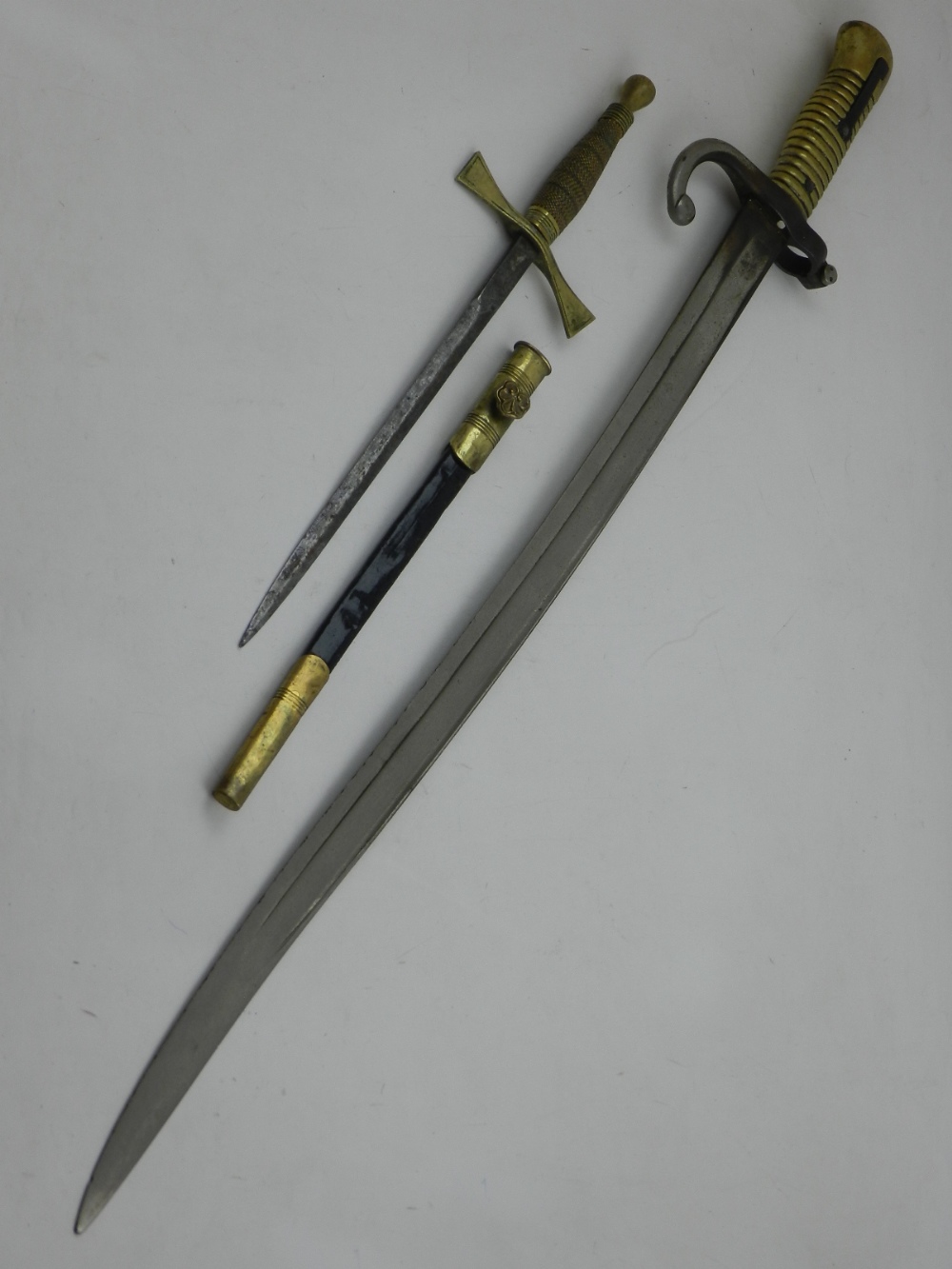 A late 19th century French bayonet, having brass handle, together with one Masonic dagger.