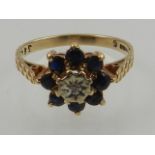 A 9 carat yellow gold, sapphire, and diamond floral cluster ring.